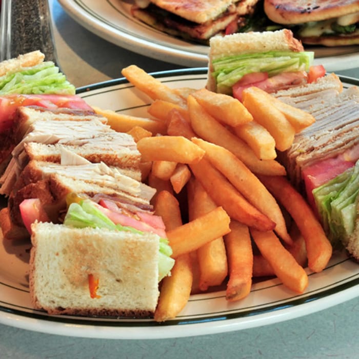 Sliced Turkey and Bacon Triple Decker Sandwich.