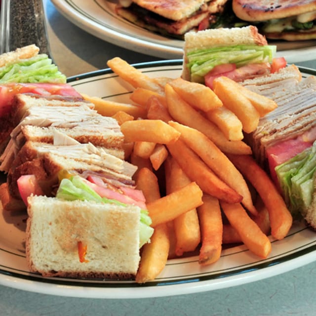 Sliced Turkey and Bacon Triple Decker Sandwich.